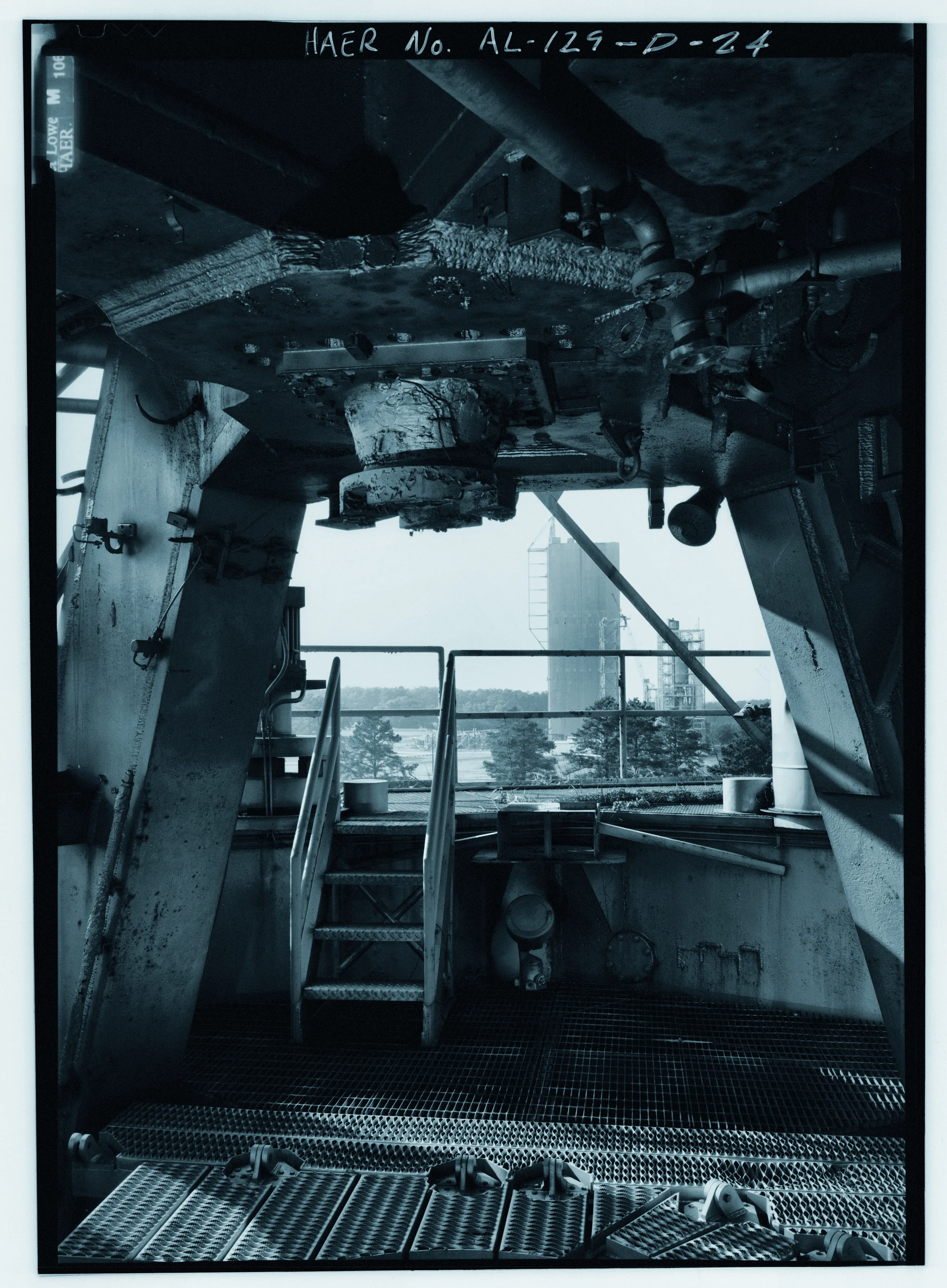 Close-up of mount for f-1 engine on static test tower with structural dynamics test stand in distance