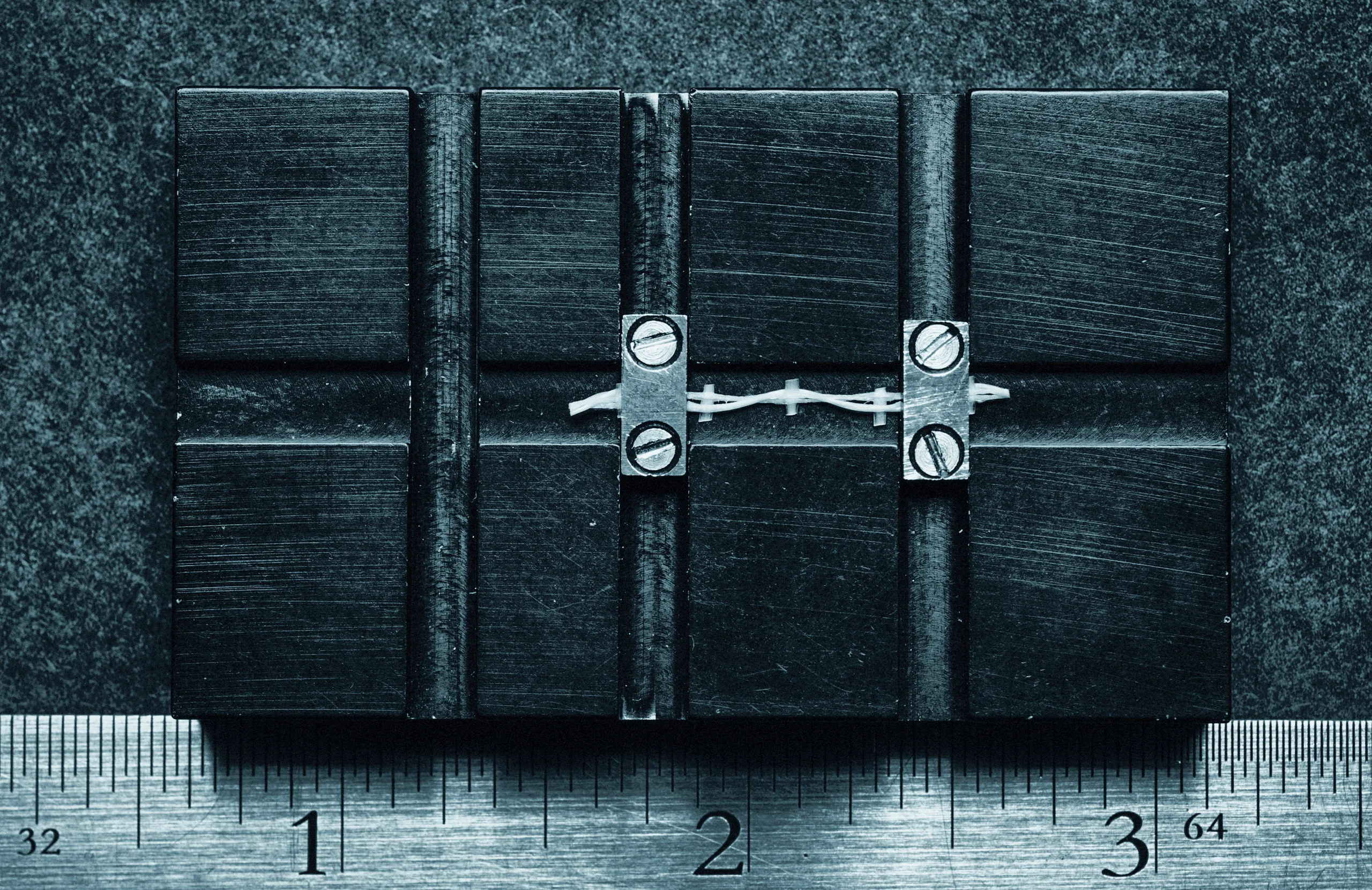 Candidate solar array material samples laid against a steel rule