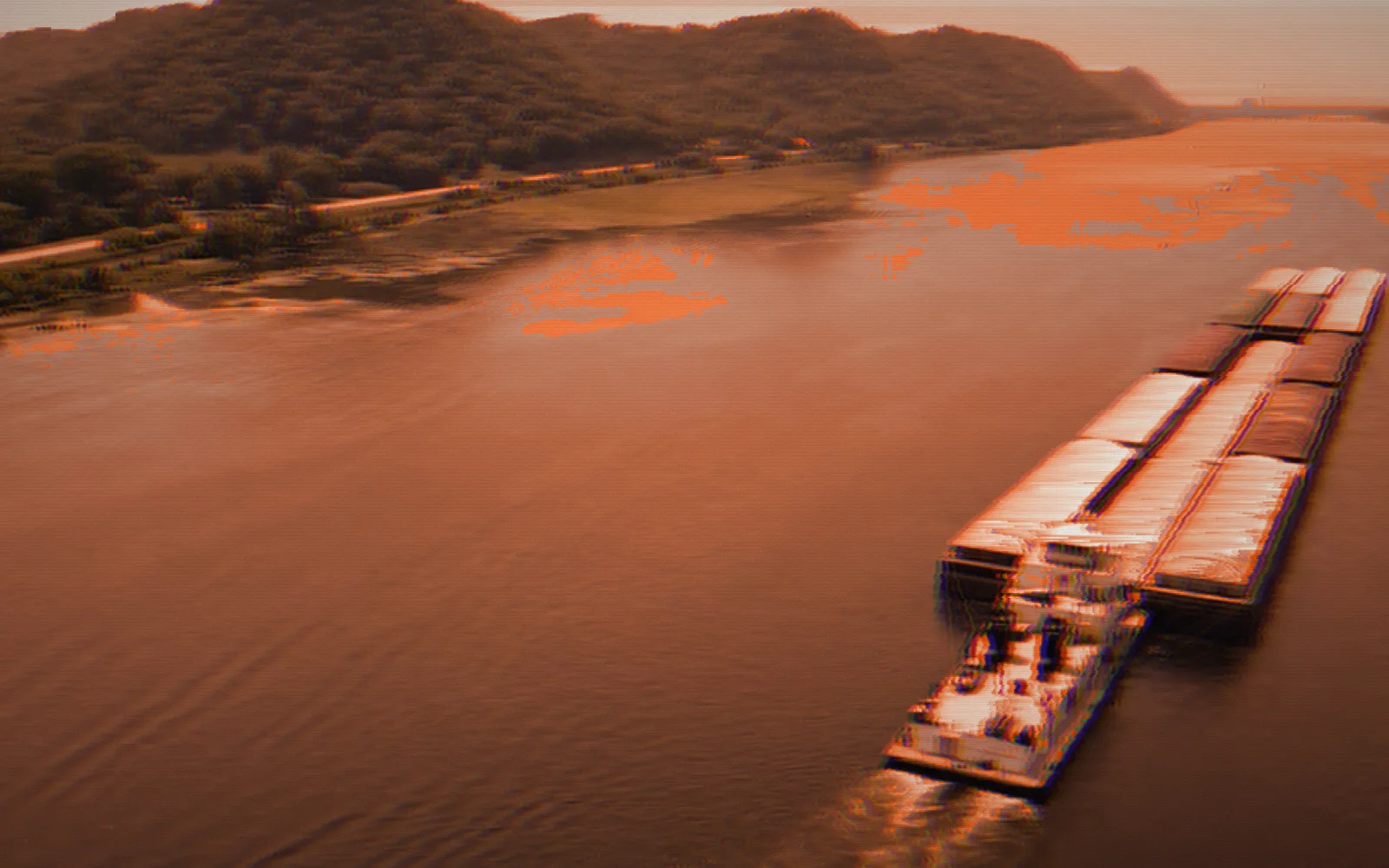 Towboat and barges — Mississippi River, 2023; the film broken up by digital glitches, pixel-sorted in the brand's orange