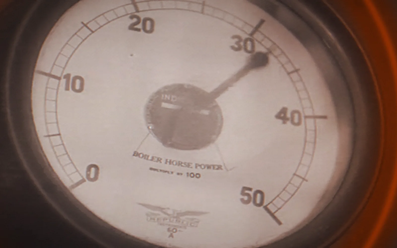 A gauge, read — Master Hands, 1936; a disruption moves through the picture as a ring, pixel-sorted in the brand's orange