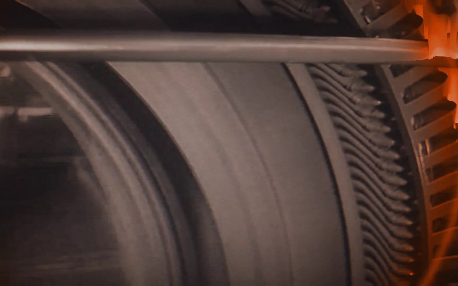 Gear being cut — Master Hands, 1936; a disruption moves through the picture as a ring, pixel-sorted in the brand's orange