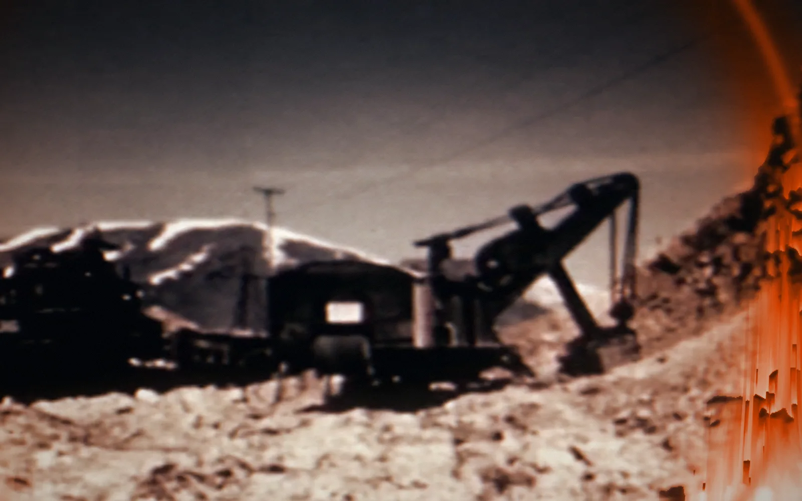 Power shovel at the pit — Copper Mining and Smelting (undated); a disruption moves through the picture as a ring, pixel-sorted in the brand's orange